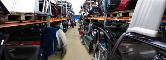 Office furniture and steel racks stacked for pickup